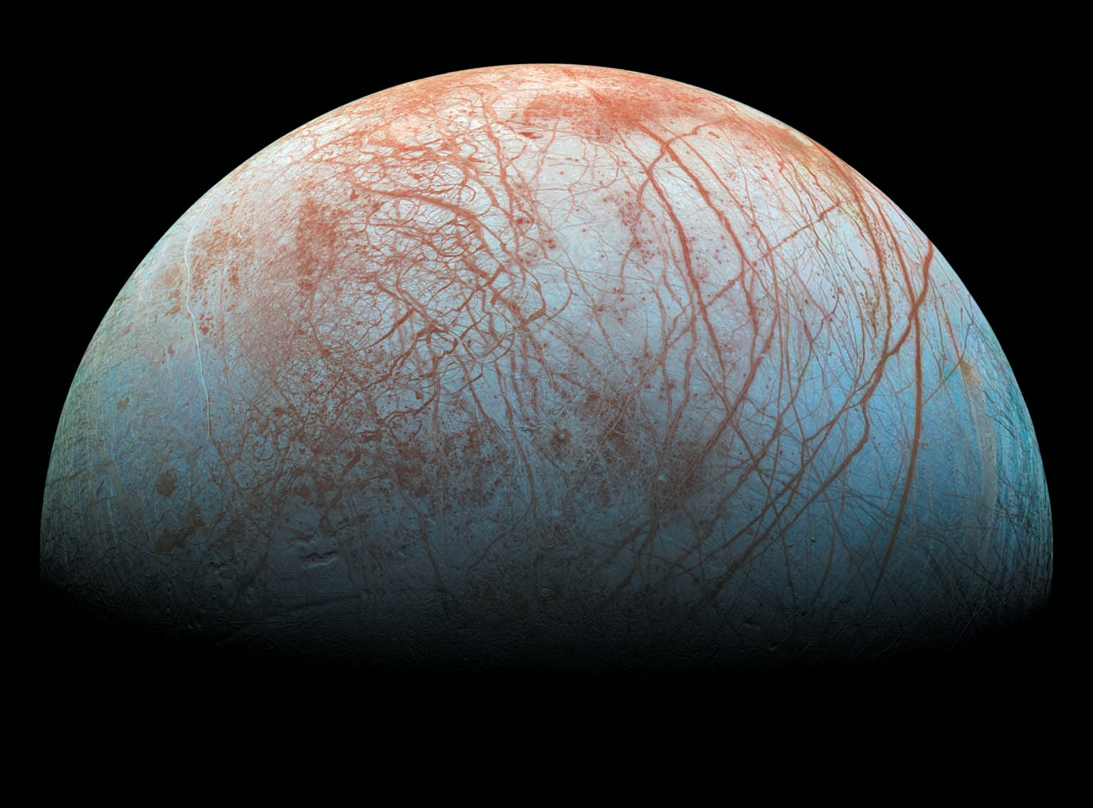 View of Jupiter’s moon Europa, shown against a black backdrop.